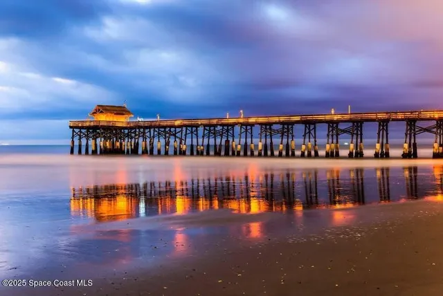 a view of a swimming pool with an outdoor seating and a floor to ceiling window