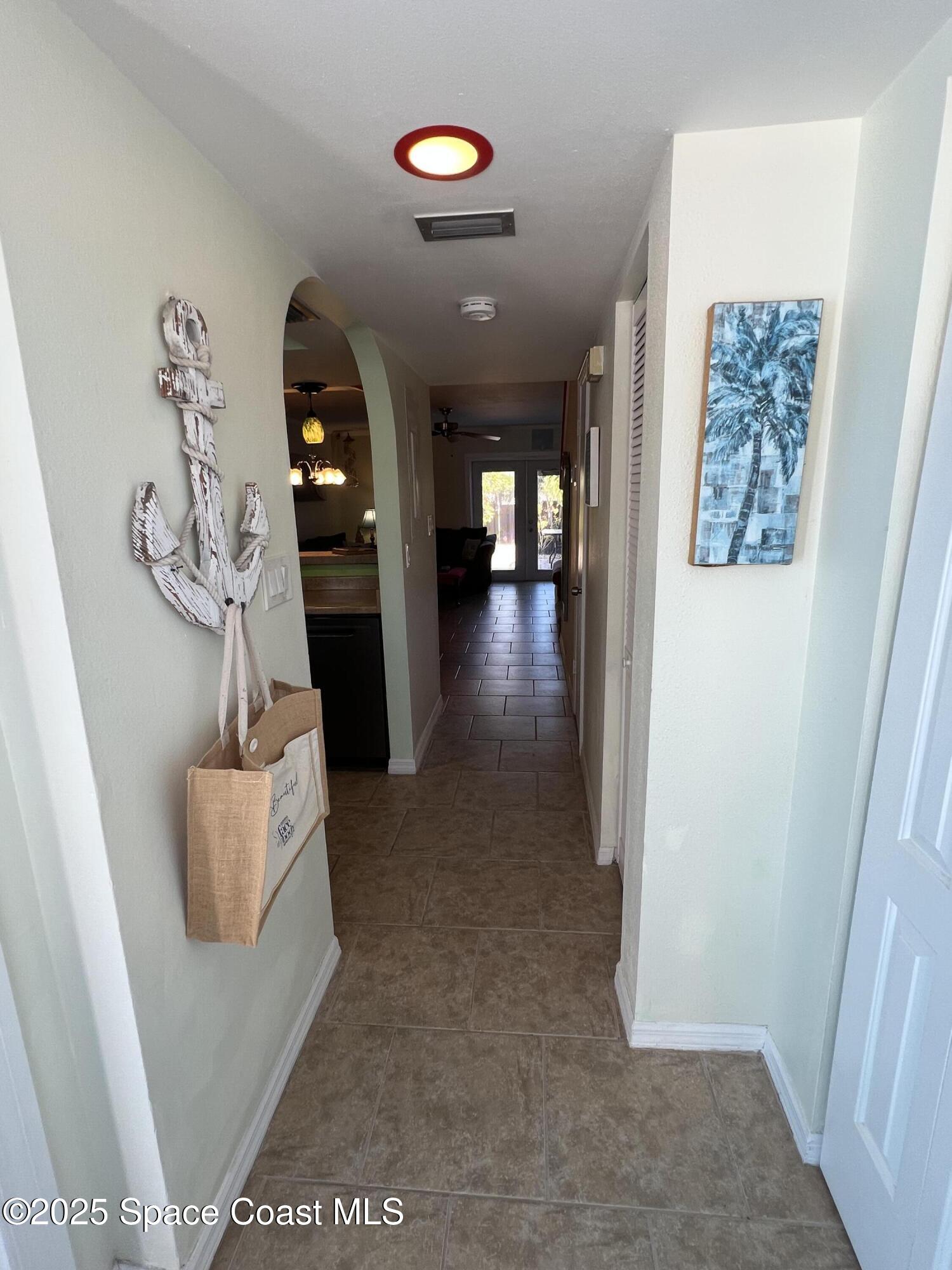 299 Chandler Street, Unit F Cape Canaveral, FL 32920 - Photo 4 of 26 a living room with furniture and a wooden floor