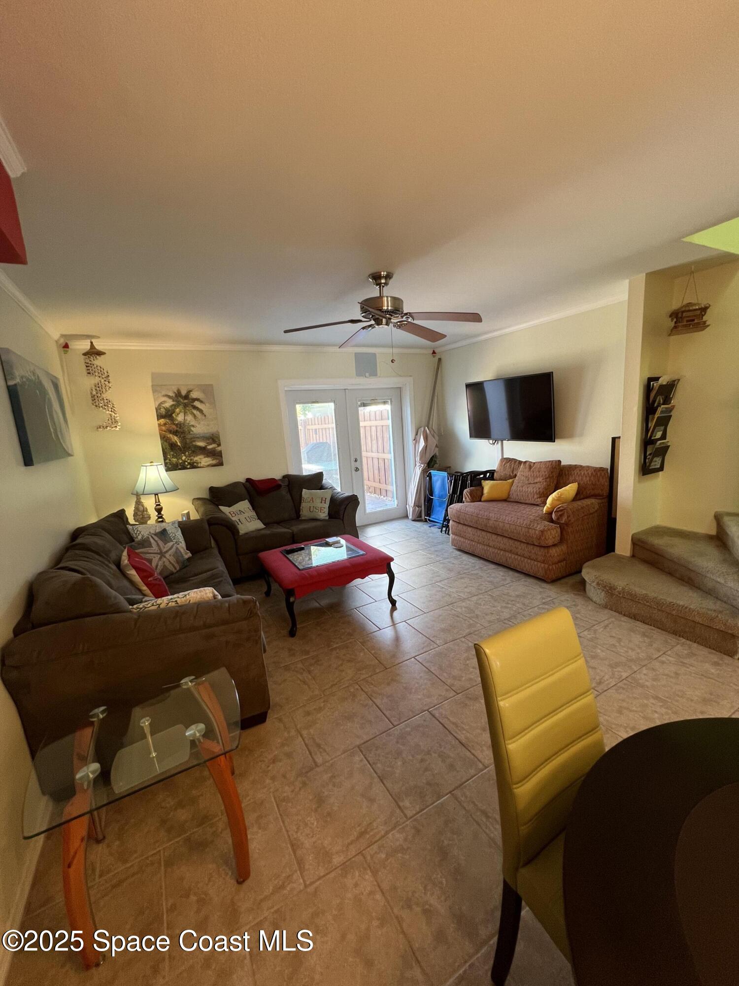 299 Chandler Street, Unit F Cape Canaveral, FL 32920 - Photo 8 of 26 a living room with furniture and a large window