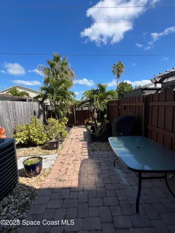 a view of a backyard with sitting area