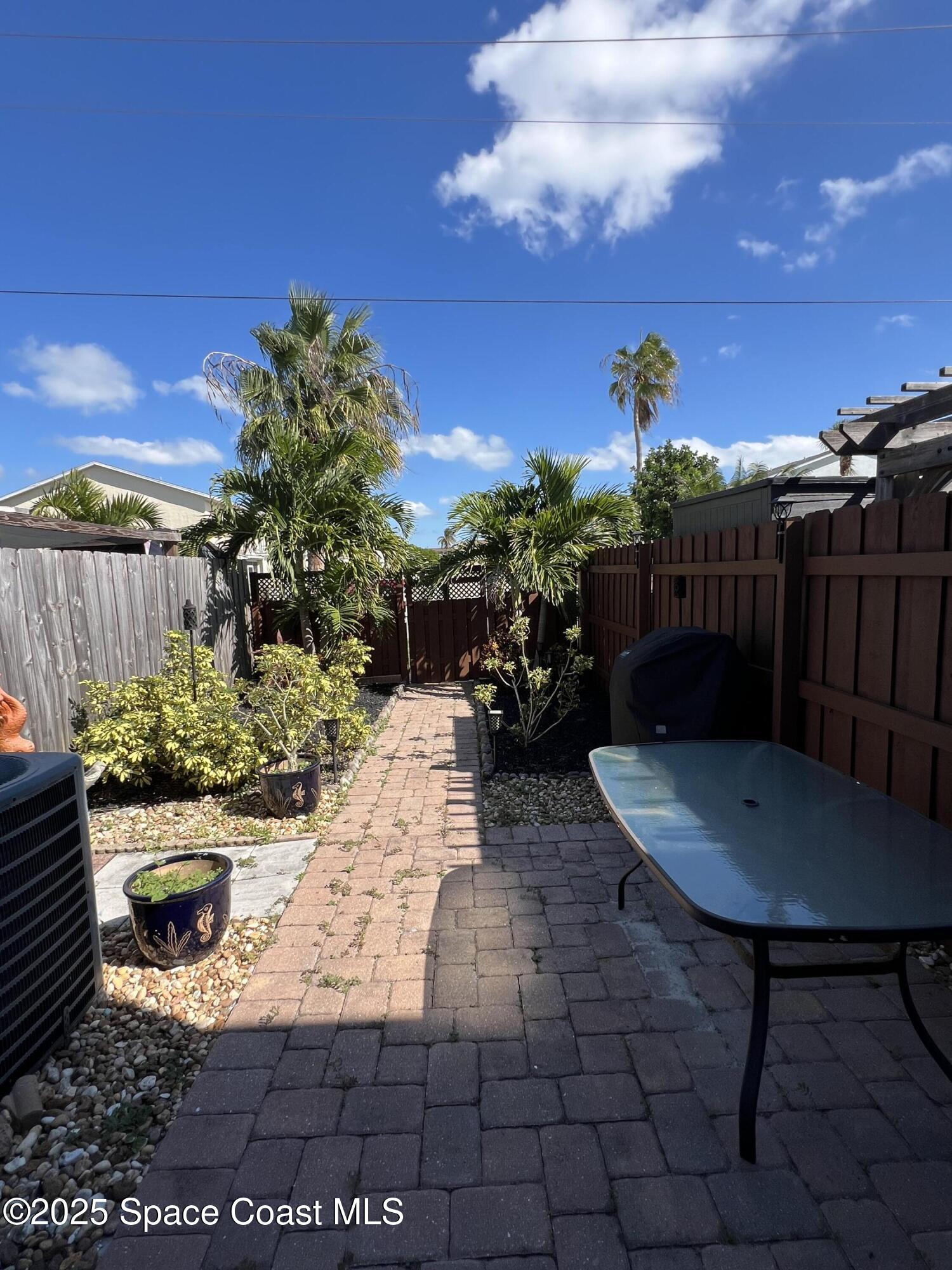 299 Chandler Street, Unit F Cape Canaveral, FL 32920 - Photo 9 of 26 a view of a backyard with sitting area