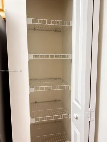 an empty room with a window and a ceiling fan