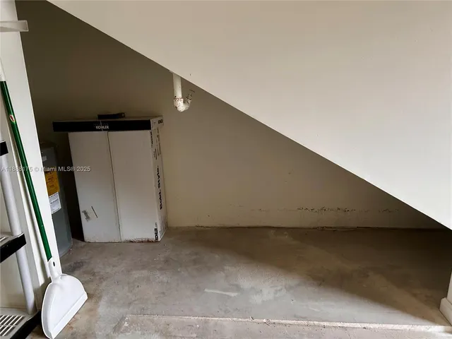 a view of a tennis ground with large trees