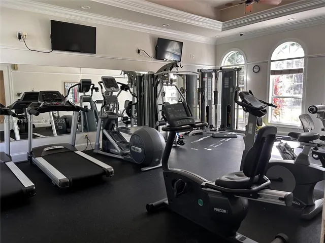 a room with gym equipment and windows