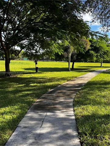 a view of a swimming pool with a yard