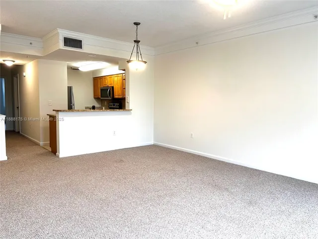 a view of a room with a kitchen