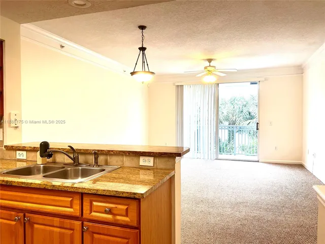 a view of a kitchen with a sink and a window