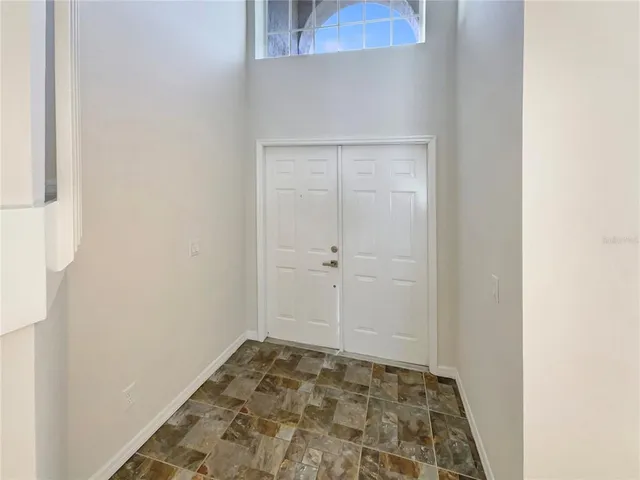 a view of a room with a window and wooden floor