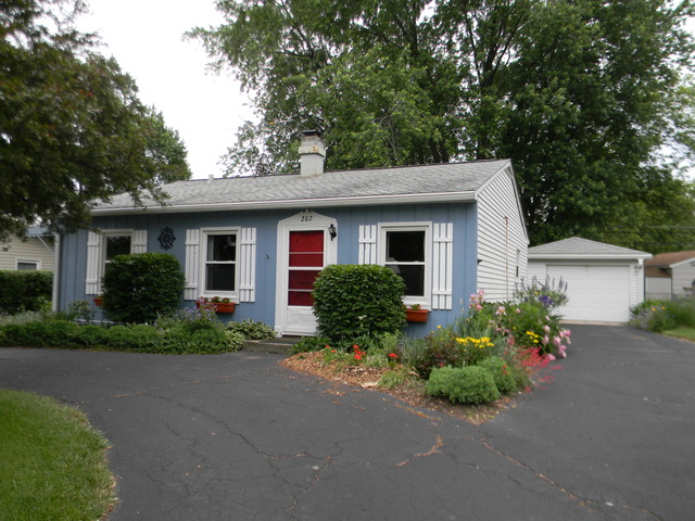 207 East Schaumburg Road Streamwood, IL 60107 - Photo 1 of 12 front view of a house and a small yard