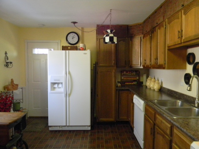 207 East Schaumburg Road Streamwood, IL 60107 - Photo 5 of 12 a kitchen with a refrigerator and a sink