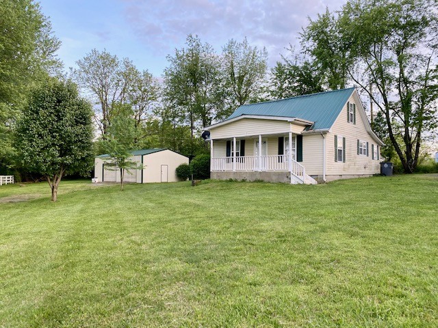 610 Days Road Lafayette, TN 37083 - Photo 1 of 13 a front view of a house with a garden and trees