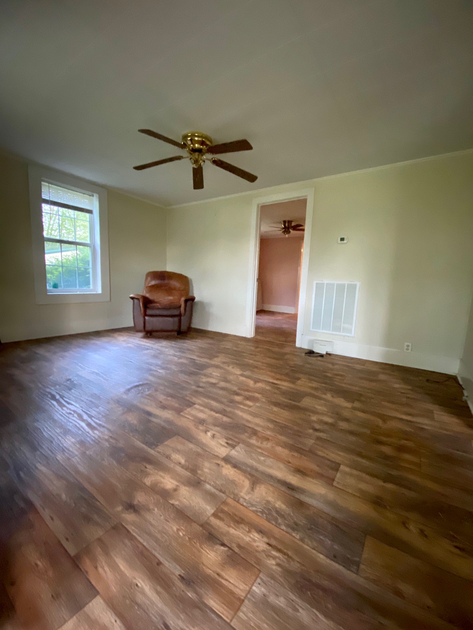 610 Days Road Lafayette, TN 37083 - Photo 7 of 13 an empty room with wooden floor ceiling fan and windows