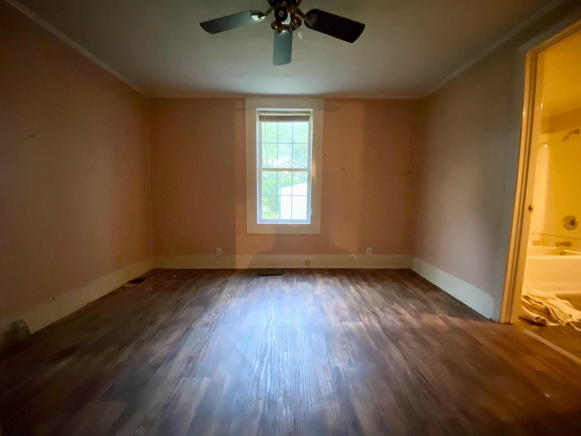 610 Days Road Lafayette, TN 37083 - Photo 10 of 13 a view of an empty room with a window and wooden floor