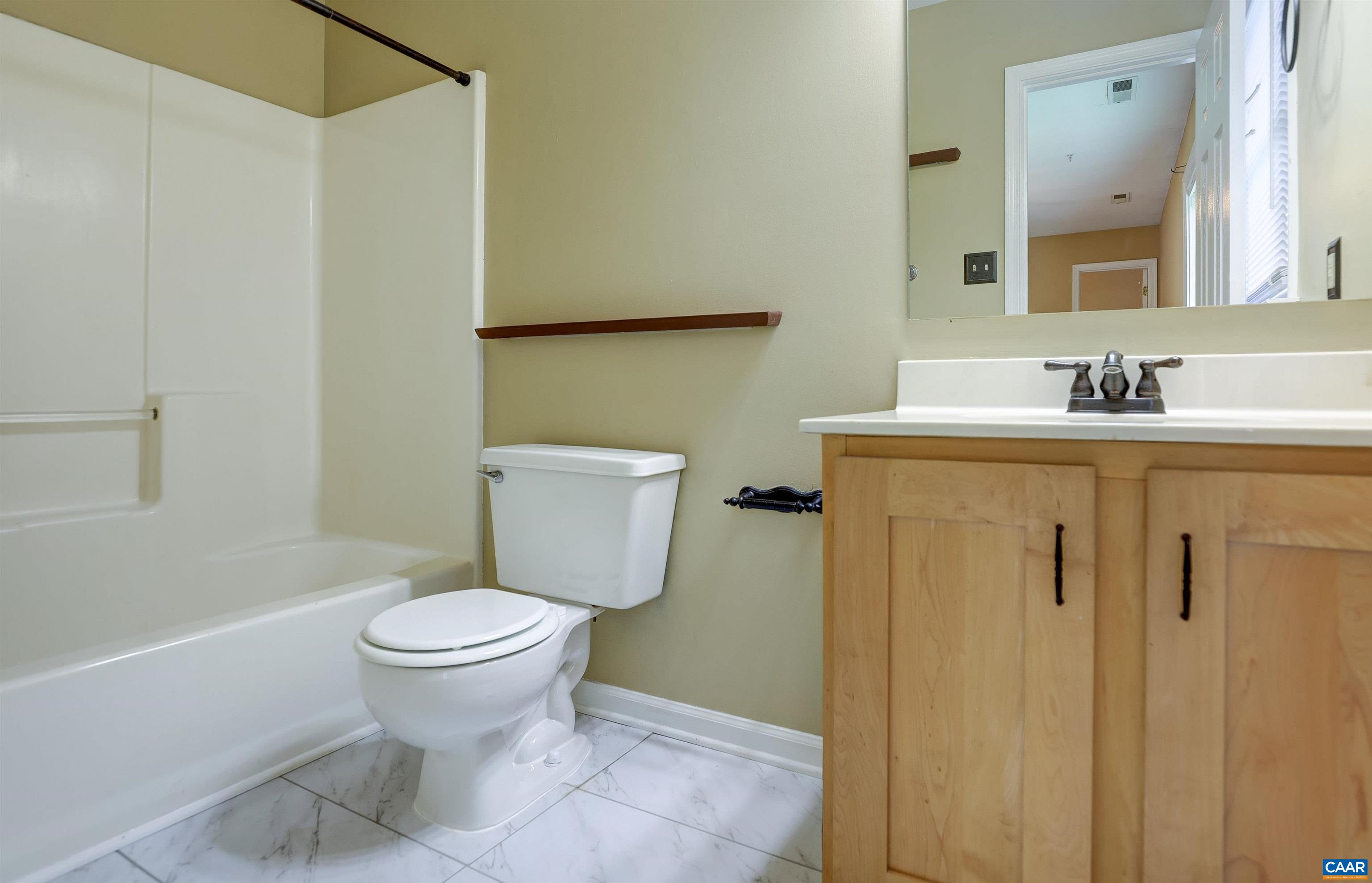 1086 West Daffodil Road Ruckersville, VA 22968 - Photo 13 of 33 a bathroom with a granite countertop toilet and a sink