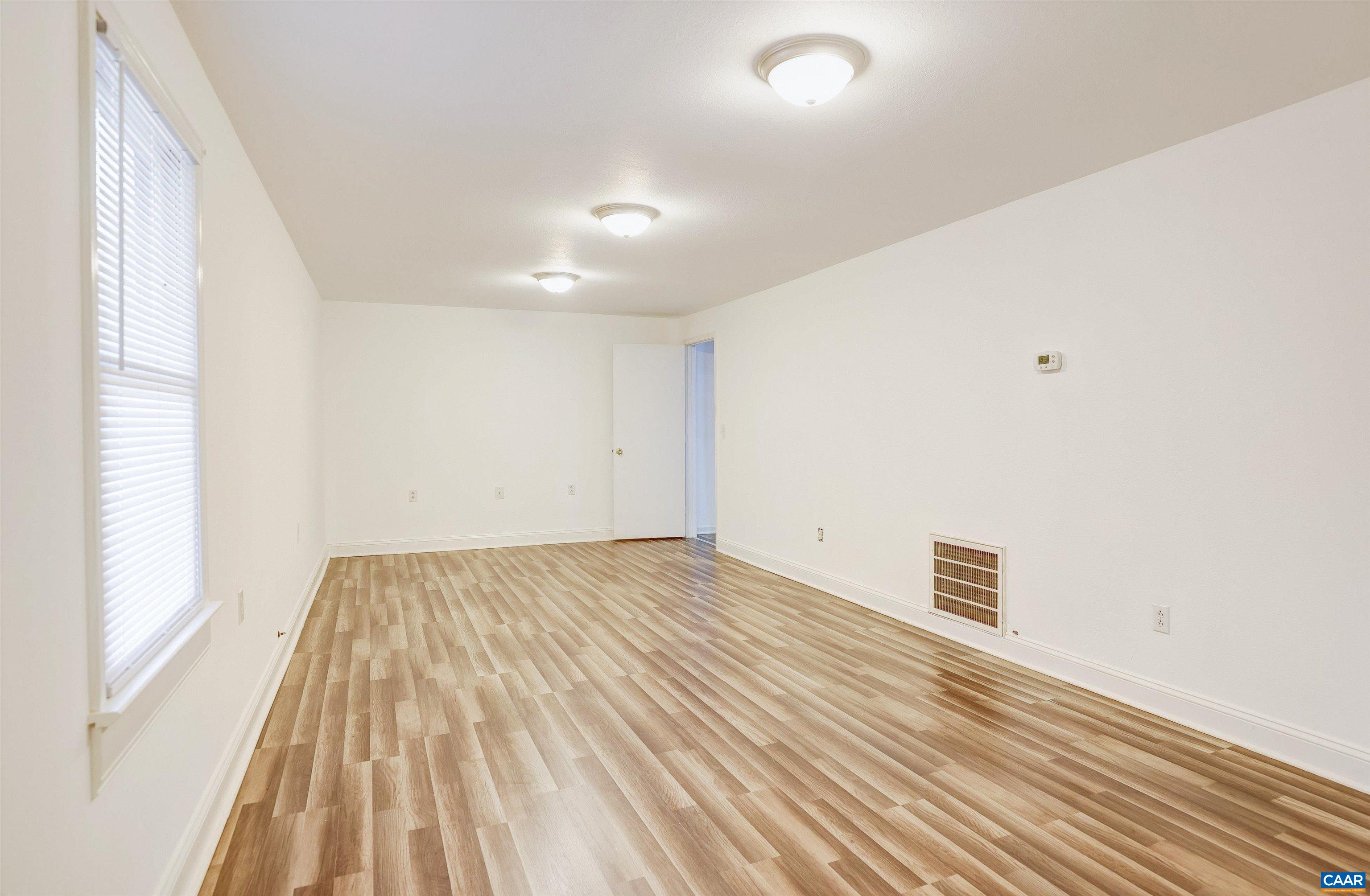 1086 West Daffodil Road Ruckersville, VA 22968 - Photo 21 of 33 a view of empty room with wooden floor
