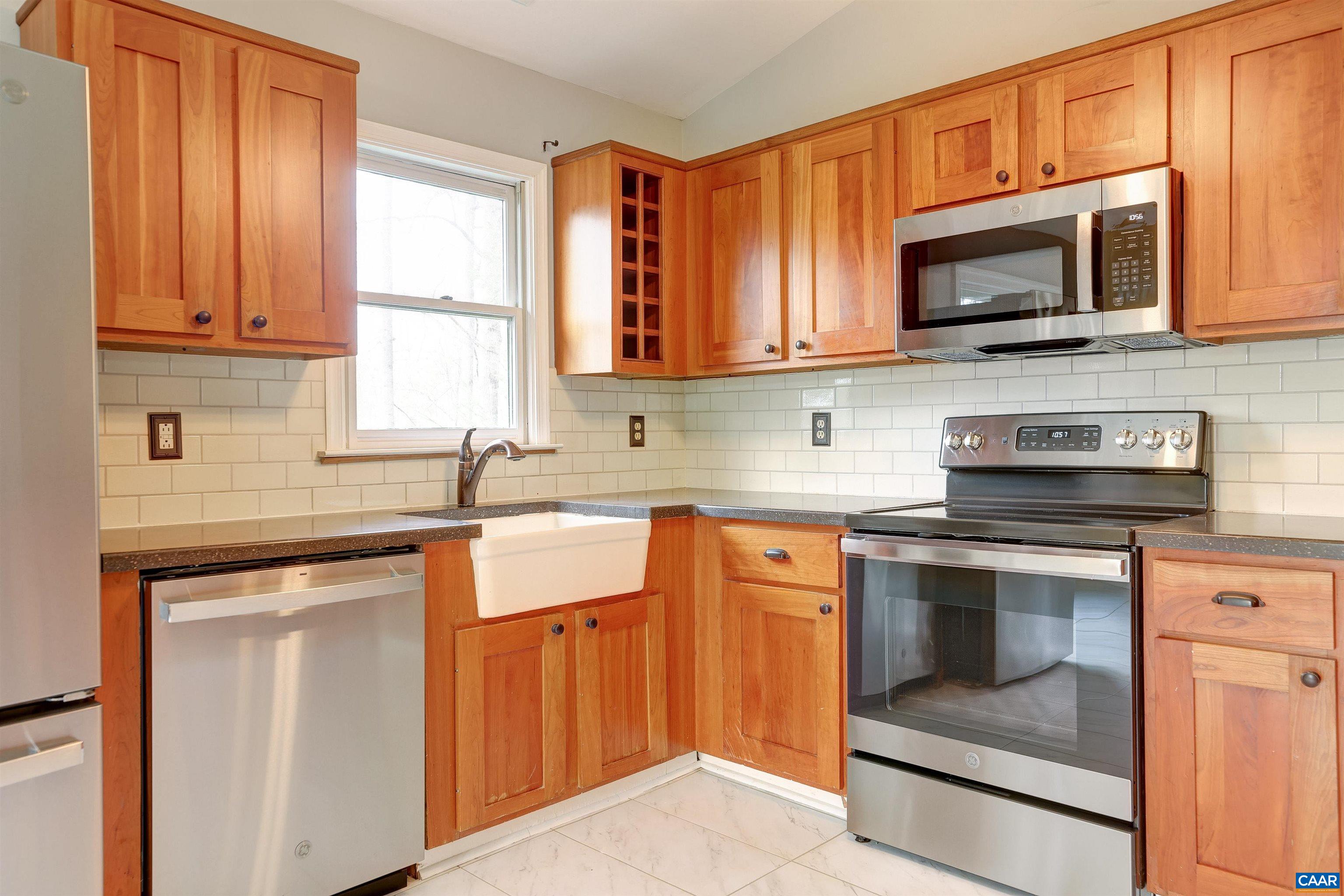 1086 West Daffodil Road Ruckersville, VA 22968 - Photo 5 of 33 a kitchen with stainless steel appliances granite countertop a stove a sink and a microwave