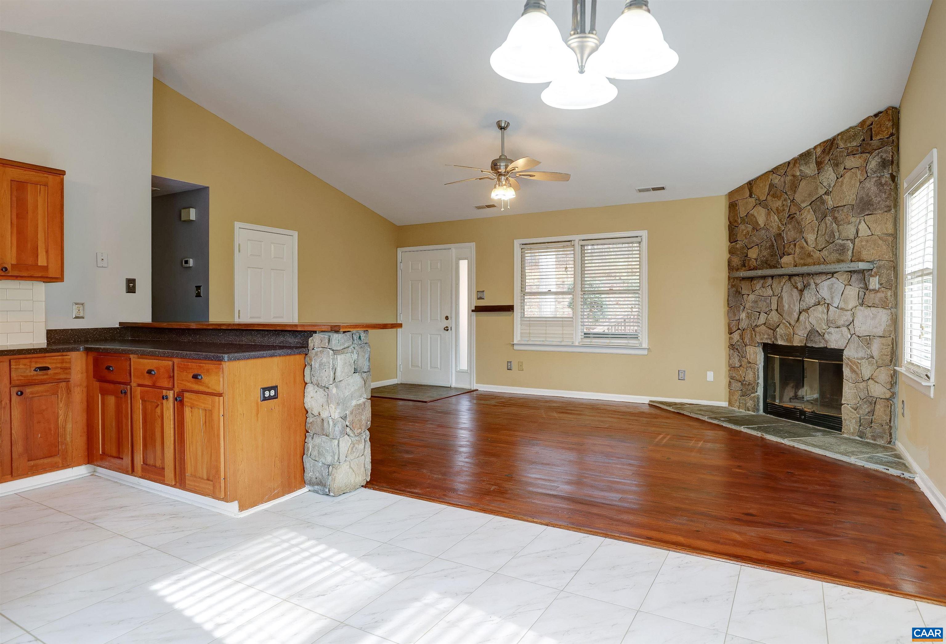 1086 West Daffodil Road Ruckersville, VA 22968 - Photo 7 of 33 a view of a kitchen with granite countertop furniture and a fireplace