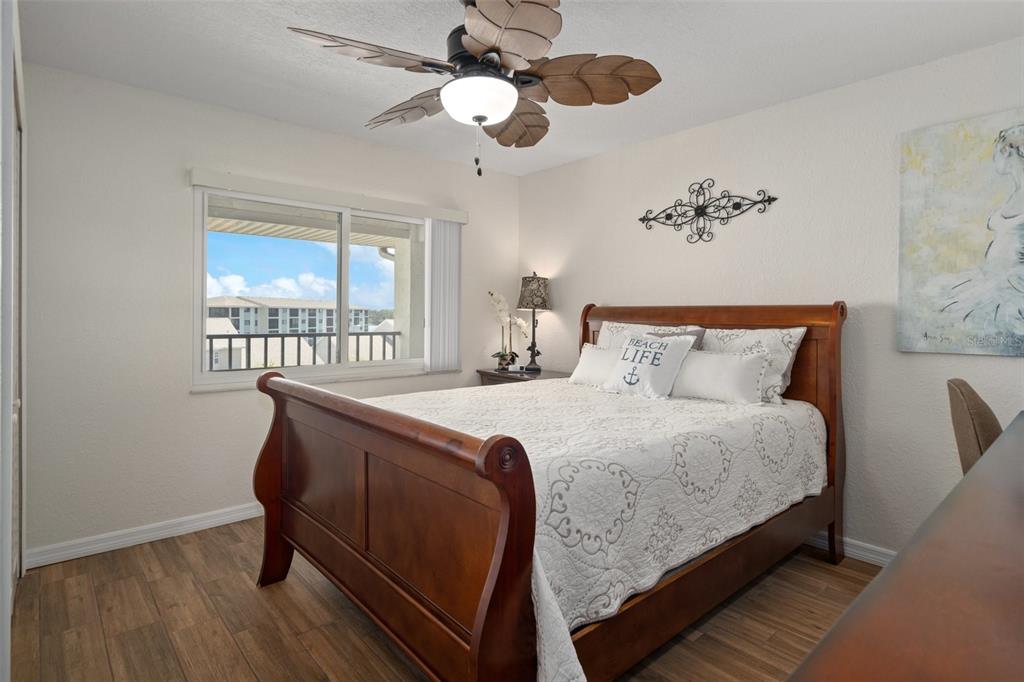 8211 Brent Street, Unit 847 Port Richey, FL 34668 - Photo 19 of 29 a bedroom with bed and a chandelier