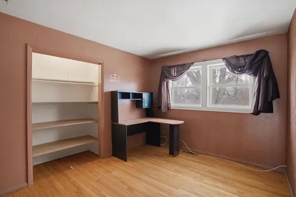 a view of room with window and wooden floor