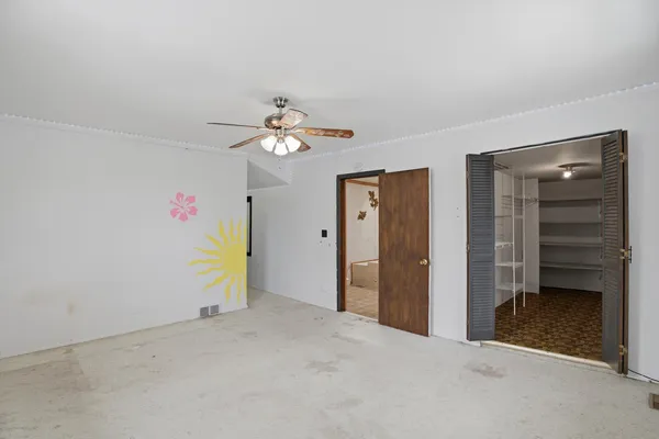 a view of an empty room with a bathroom