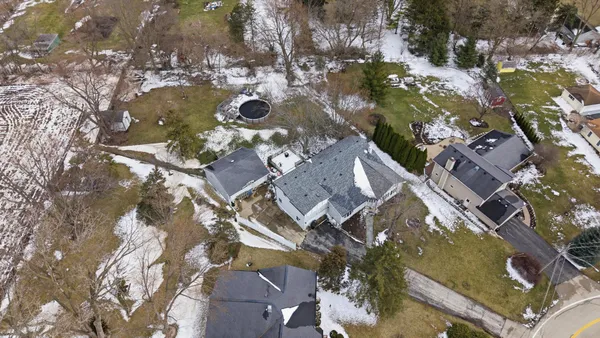 an aerial view of a house with yard swimming pool and outdoor seating