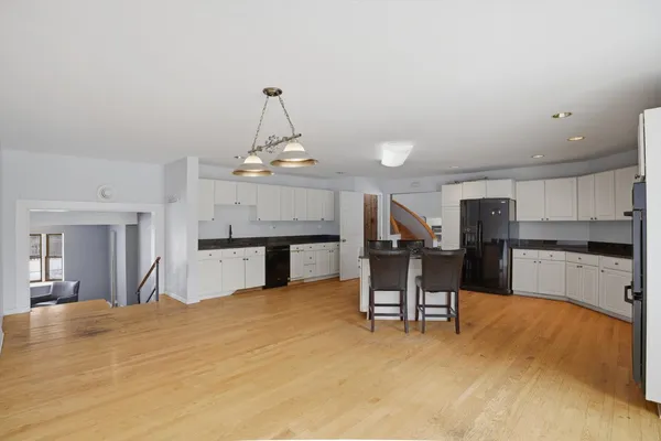 a living room with furniture and kitchen view