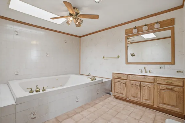 a bathroom with a bathtub sink and mirror