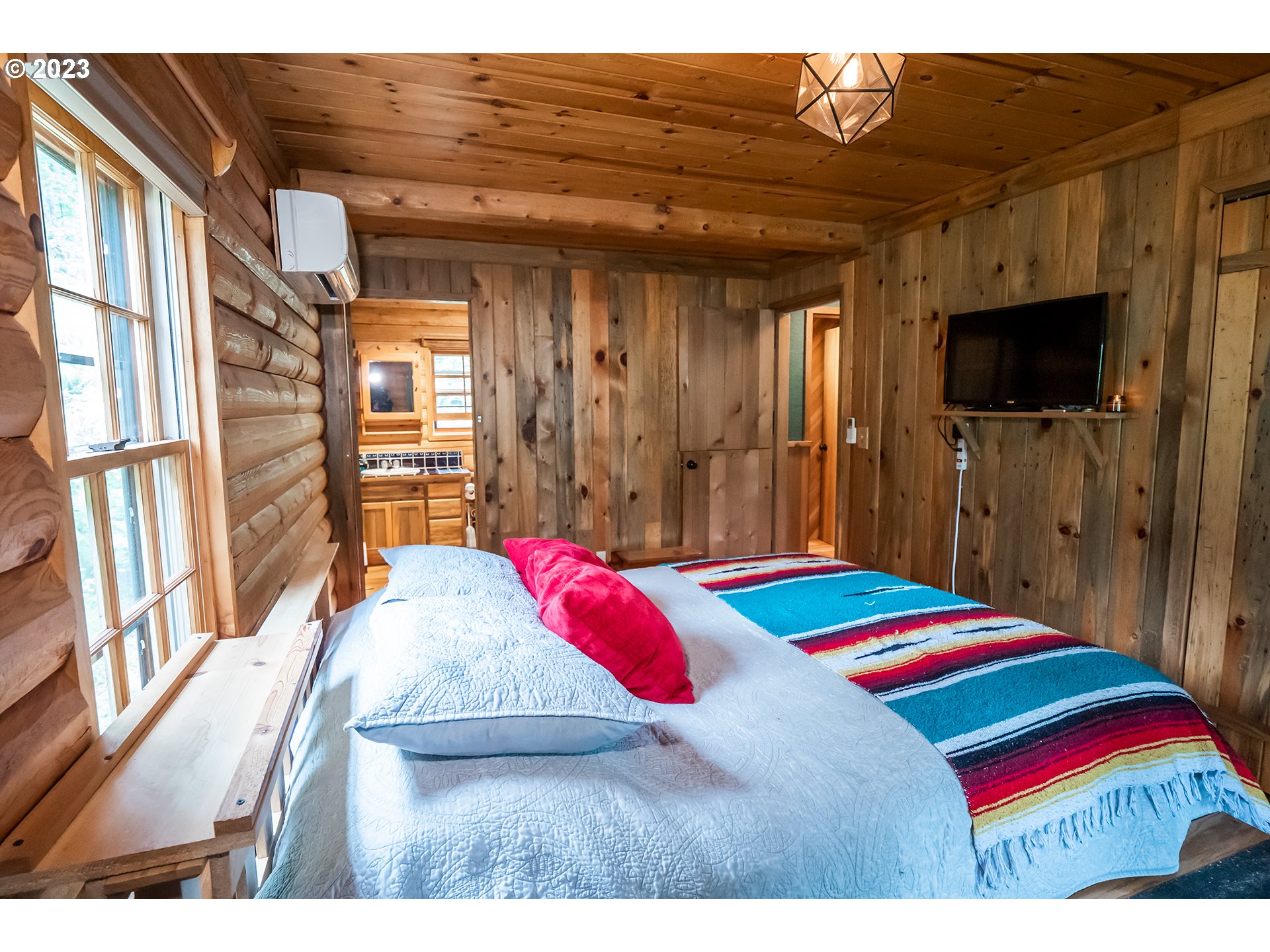 29588 Simmons Road Eugene, OR 97405 - Photo 15 of 44 a bedroom with a bed and a flat screen tv