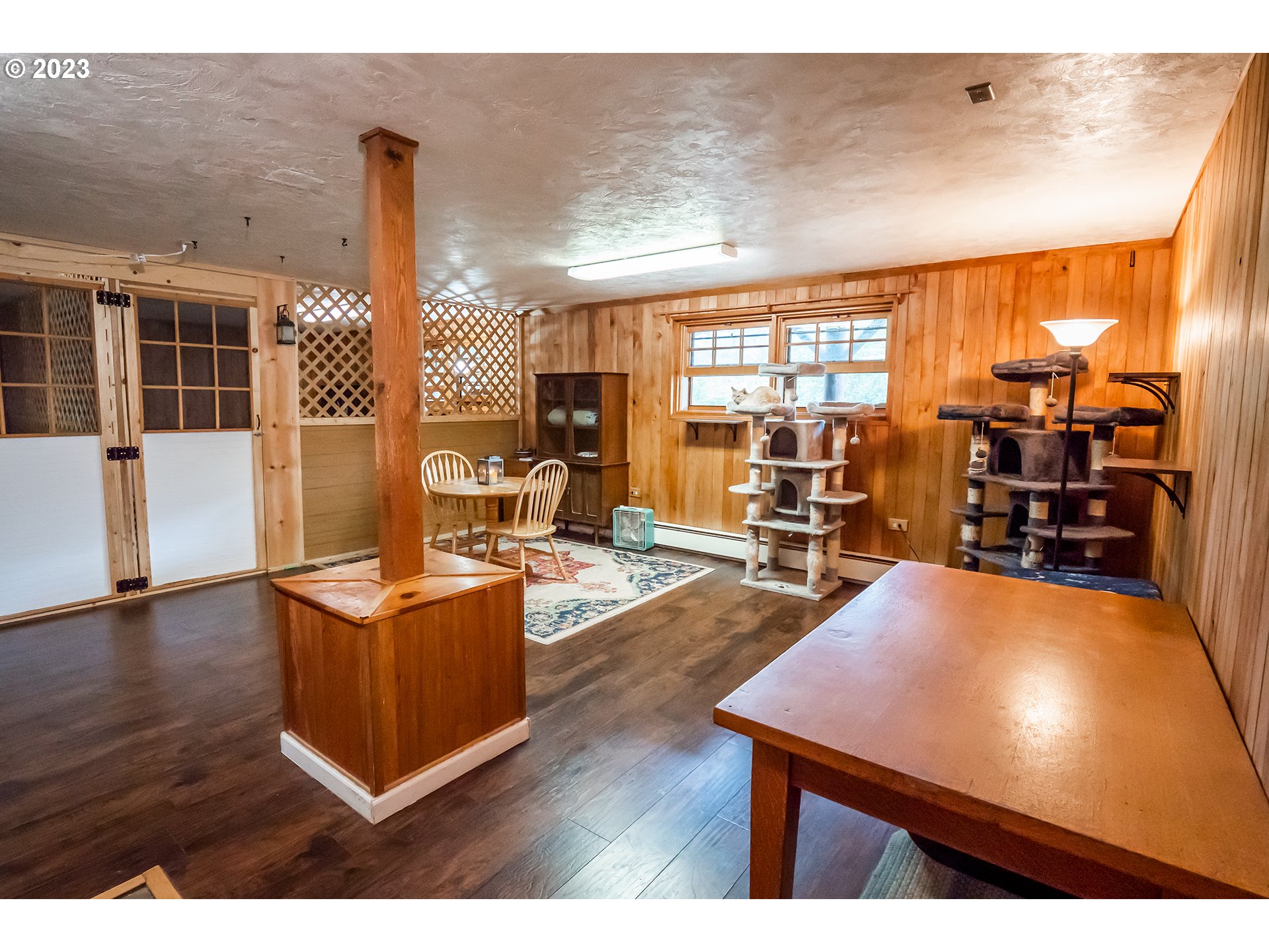 29588 Simmons Road Eugene, OR 97405 - Photo 21 of 44 a living room with furniture a wooden floor and next to a window