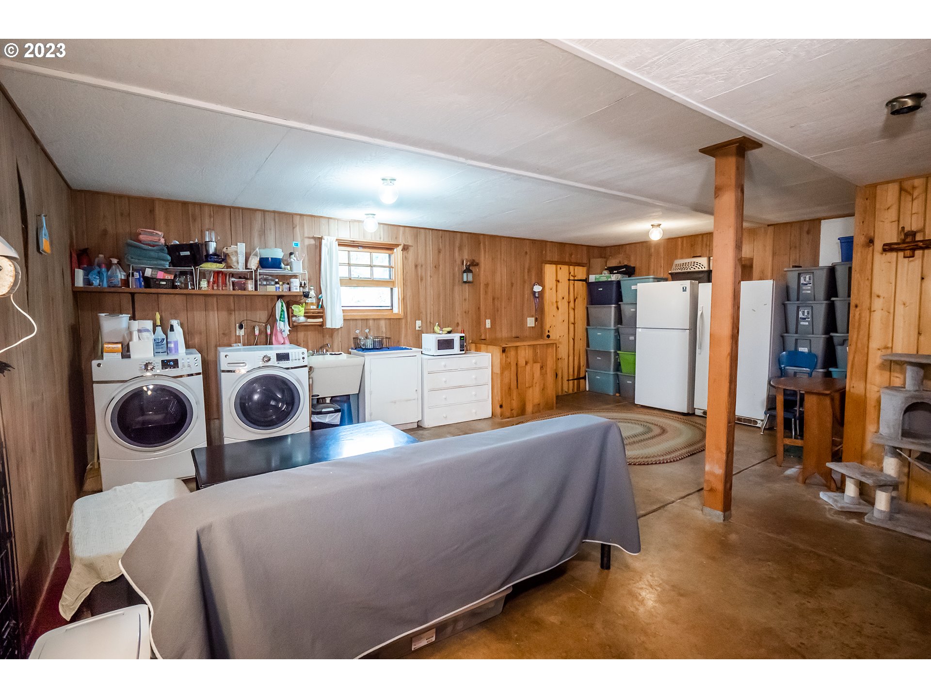 29588 Simmons Road Eugene, OR 97405 - Photo 24 of 44 a living room with furniture a flat screen tv and a refrigerator