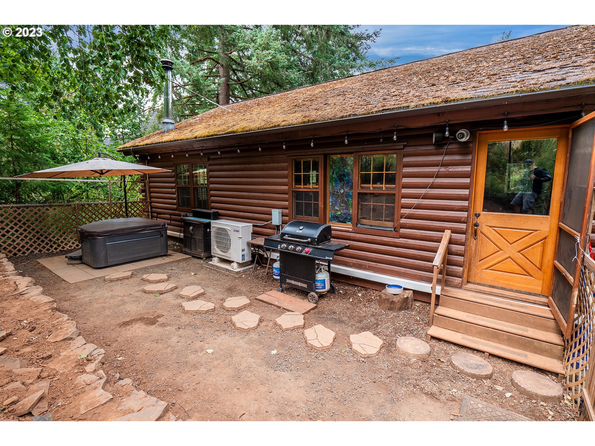 29588 Simmons Road Eugene, OR 97405 - Photo 26 of 44 a backyard of a house with barbeque oven and outdoor seating