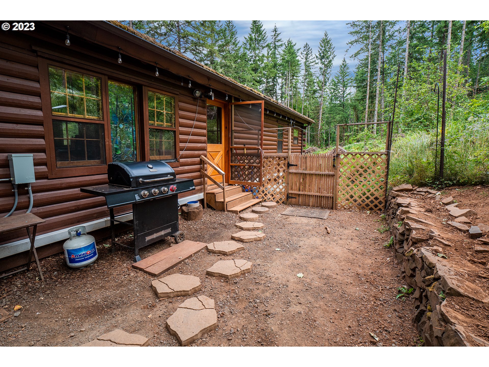 29588 Simmons Road Eugene, OR 97405 - Photo 29 of 44 a backyard of a house with barbeque oven table and chairs