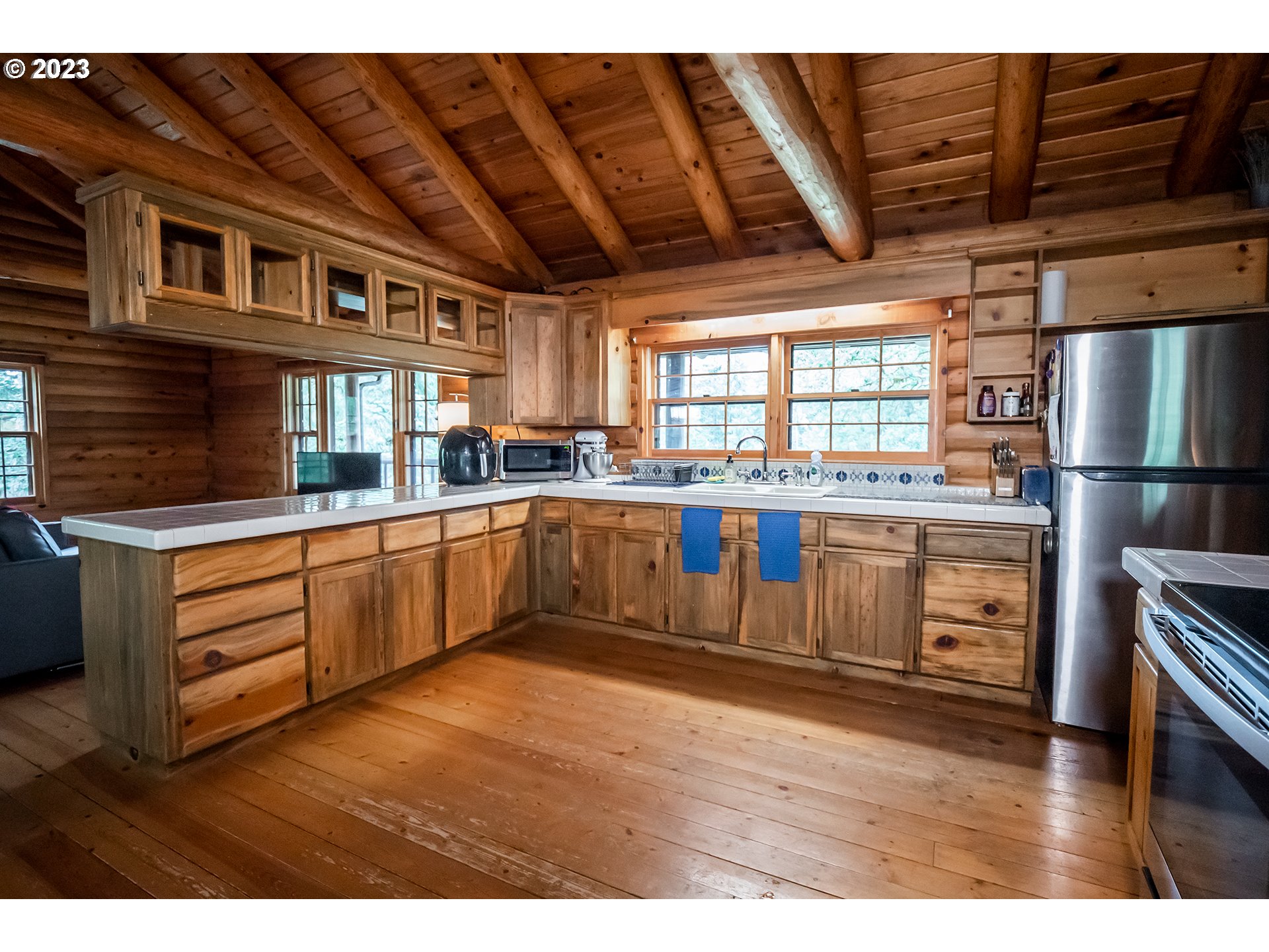 29588 Simmons Road Eugene, OR 97405 - Photo 7 of 44 a kitchen with stainless steel appliances kitchen island granite countertop a stove a sink and white cabinets