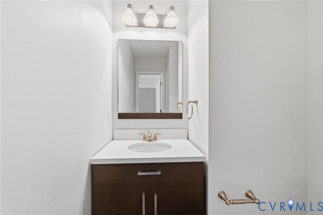 13524 Mountcastle Road Chesterfield, VA 23832 - Photo 15 of 44 Bathroom vanity featuring a dark wood-finish cabin