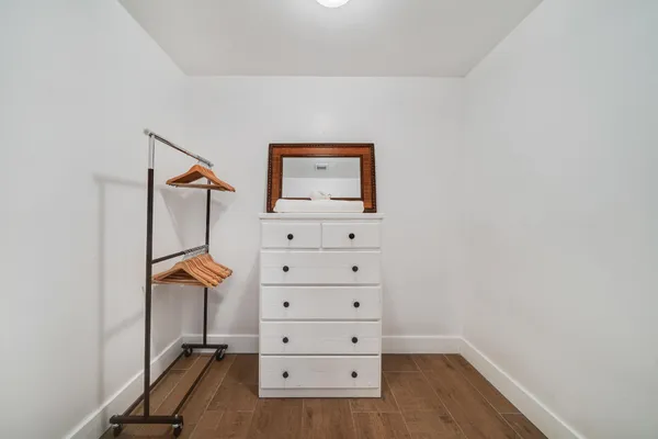 a bedroom with a bed and a flat tv screen on the dresser
