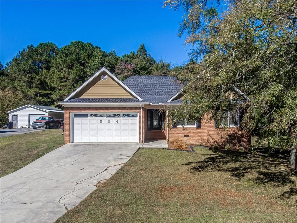554 Newtown Road Northeast Calhoun, GA 30701 - Photo 1 of 1 a front view of a house with a yard and garage