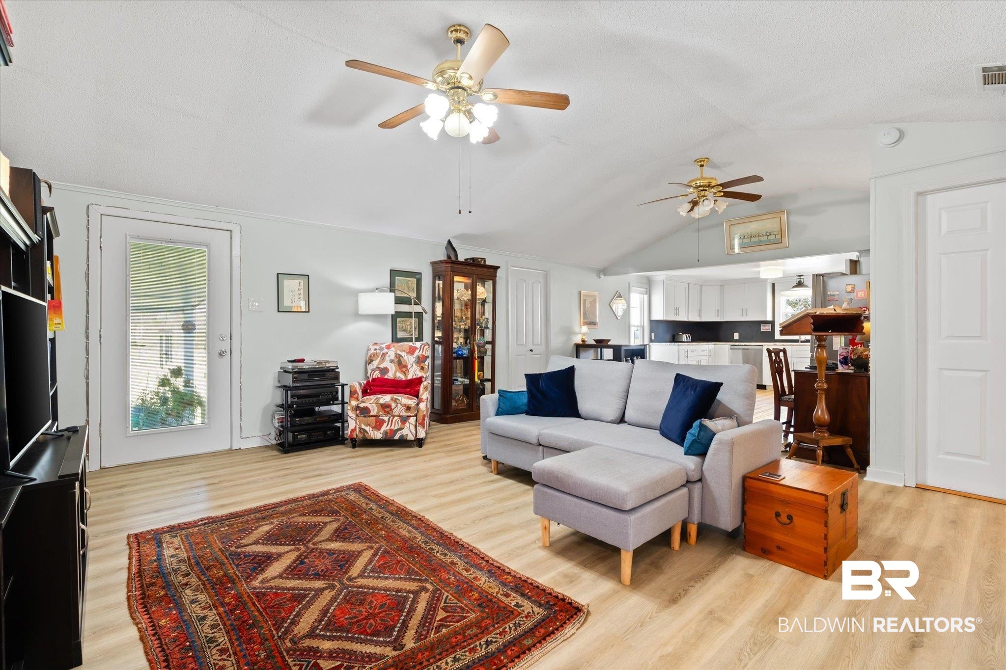 14280 Cat Deakle Road Grand Bay, AL 36541 - Photo 6 of 51 Living room featuring vaulted ceiling, light wood-type flooring, visible vents, and a ceiling fan