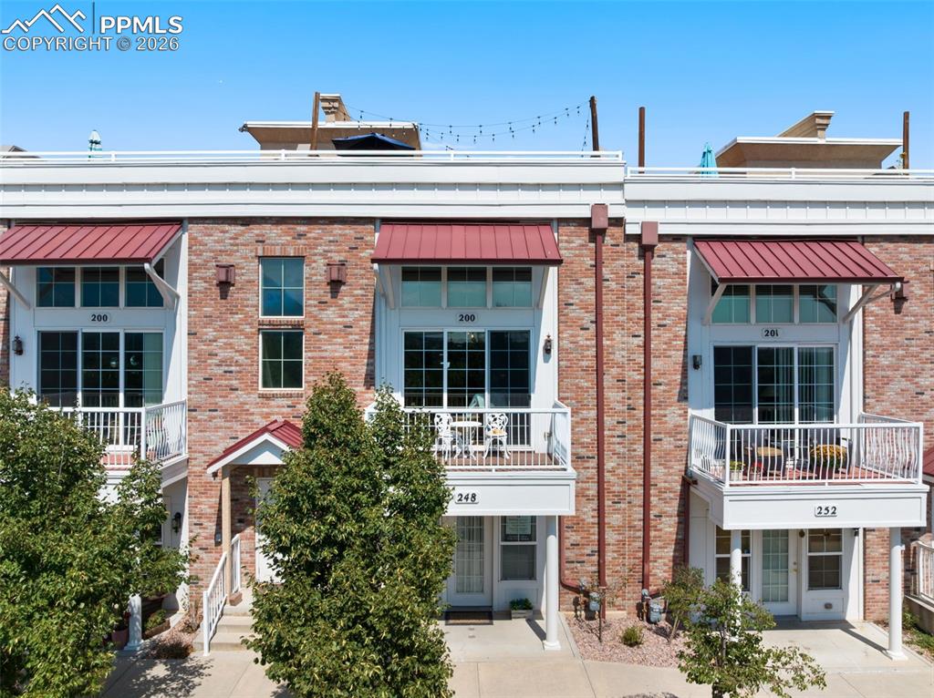 a front view of a building with a garden