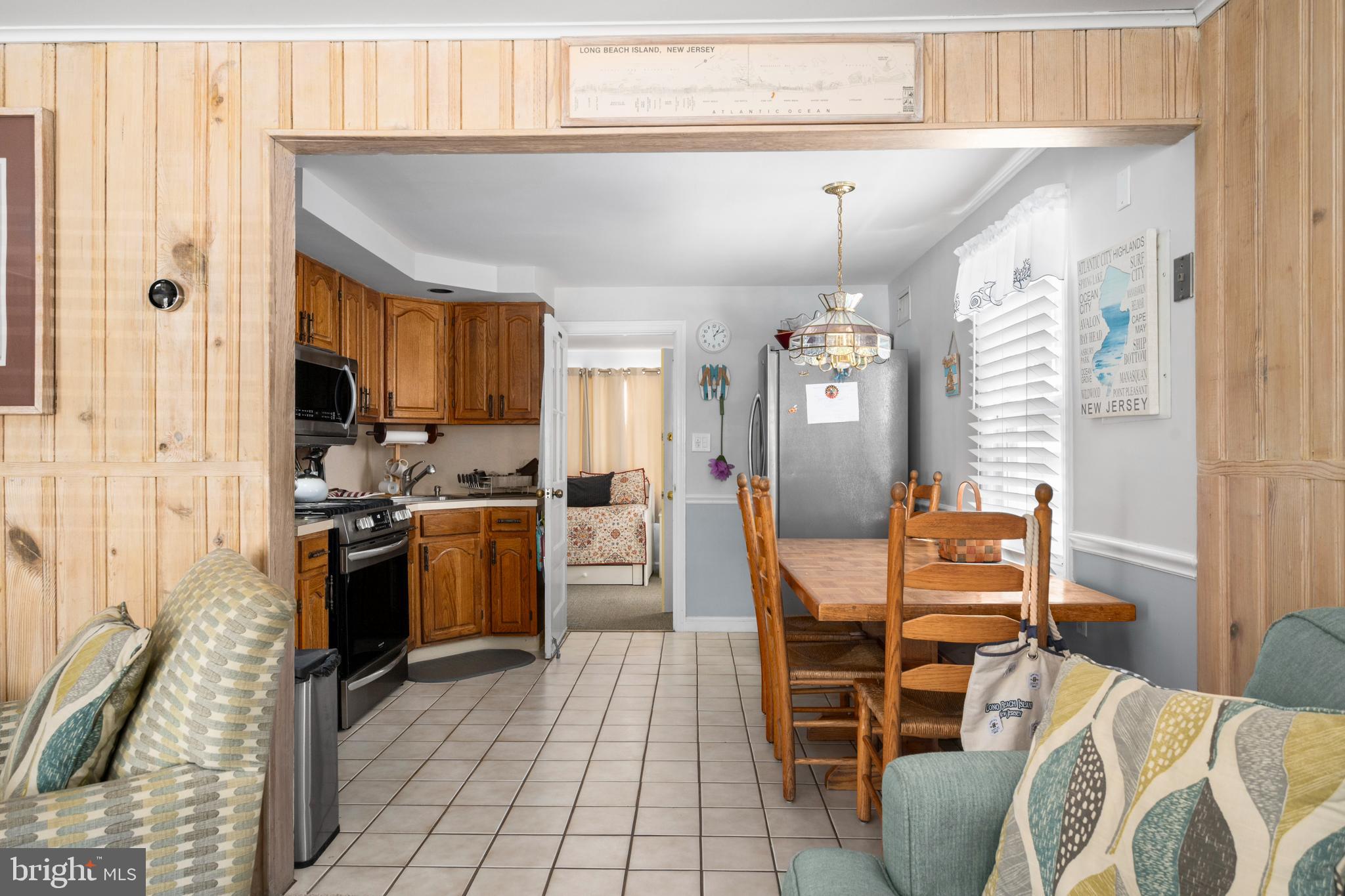 33 19th Street Surf City, NJ 08008 - Photo 15 of 63 a view of a dining room with furniture window and wooden floor