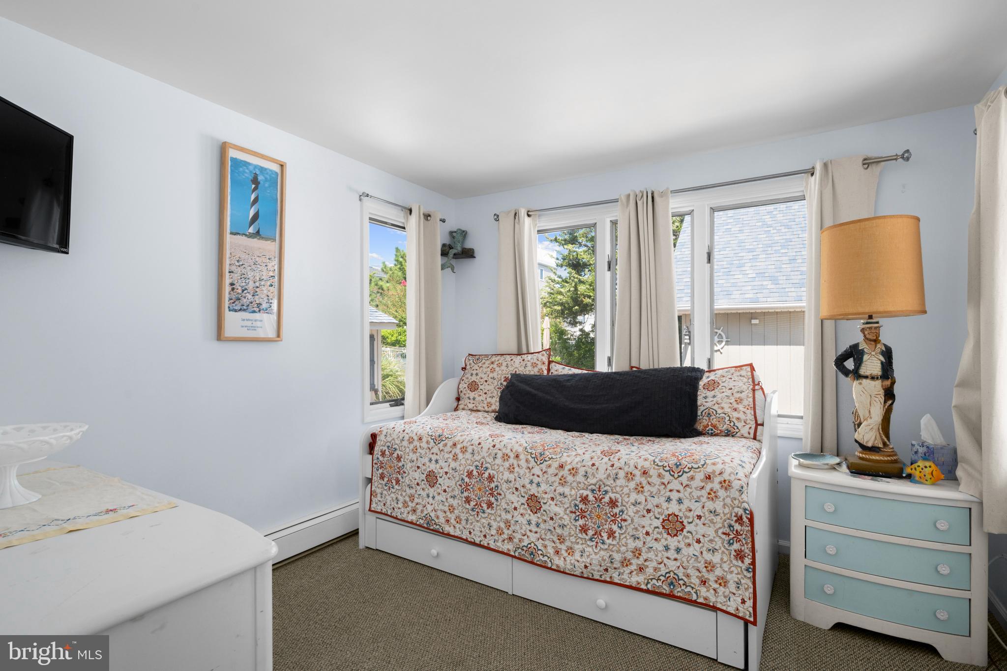 33 19th Street Surf City, NJ 08008 - Photo 17 of 63 a bedroom with a large bed and a flat tv screen on dresser