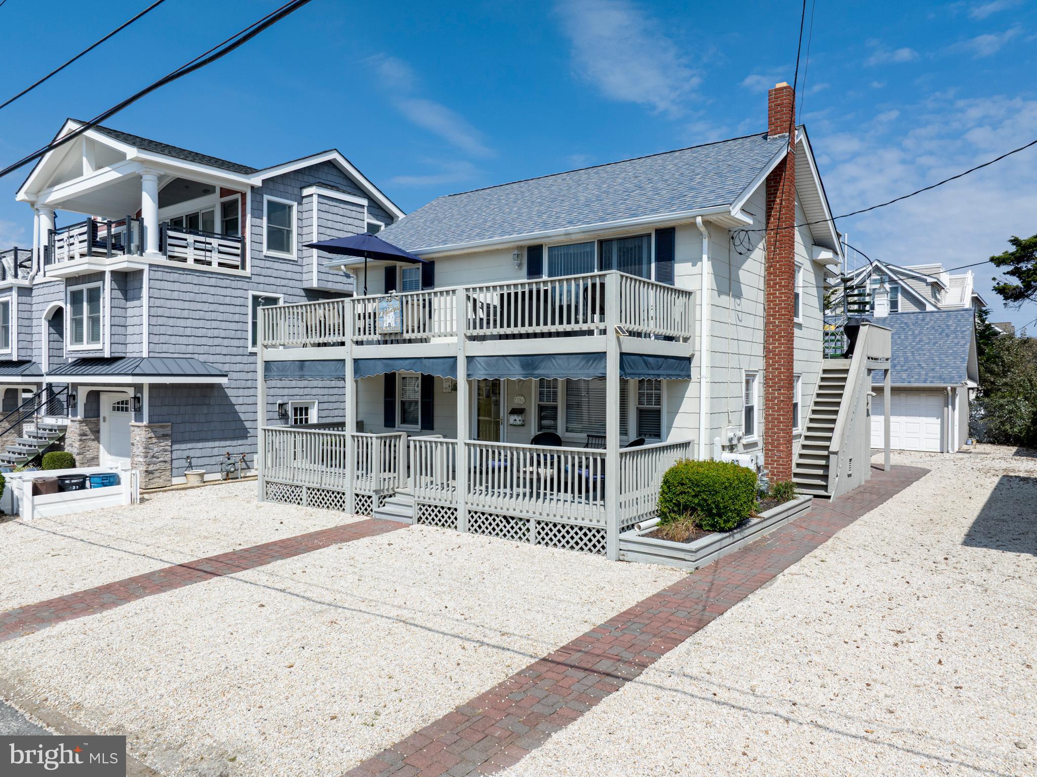 33 19th Street Surf City, NJ 08008 - Photo 2 of 63 a front view of a house with a yard