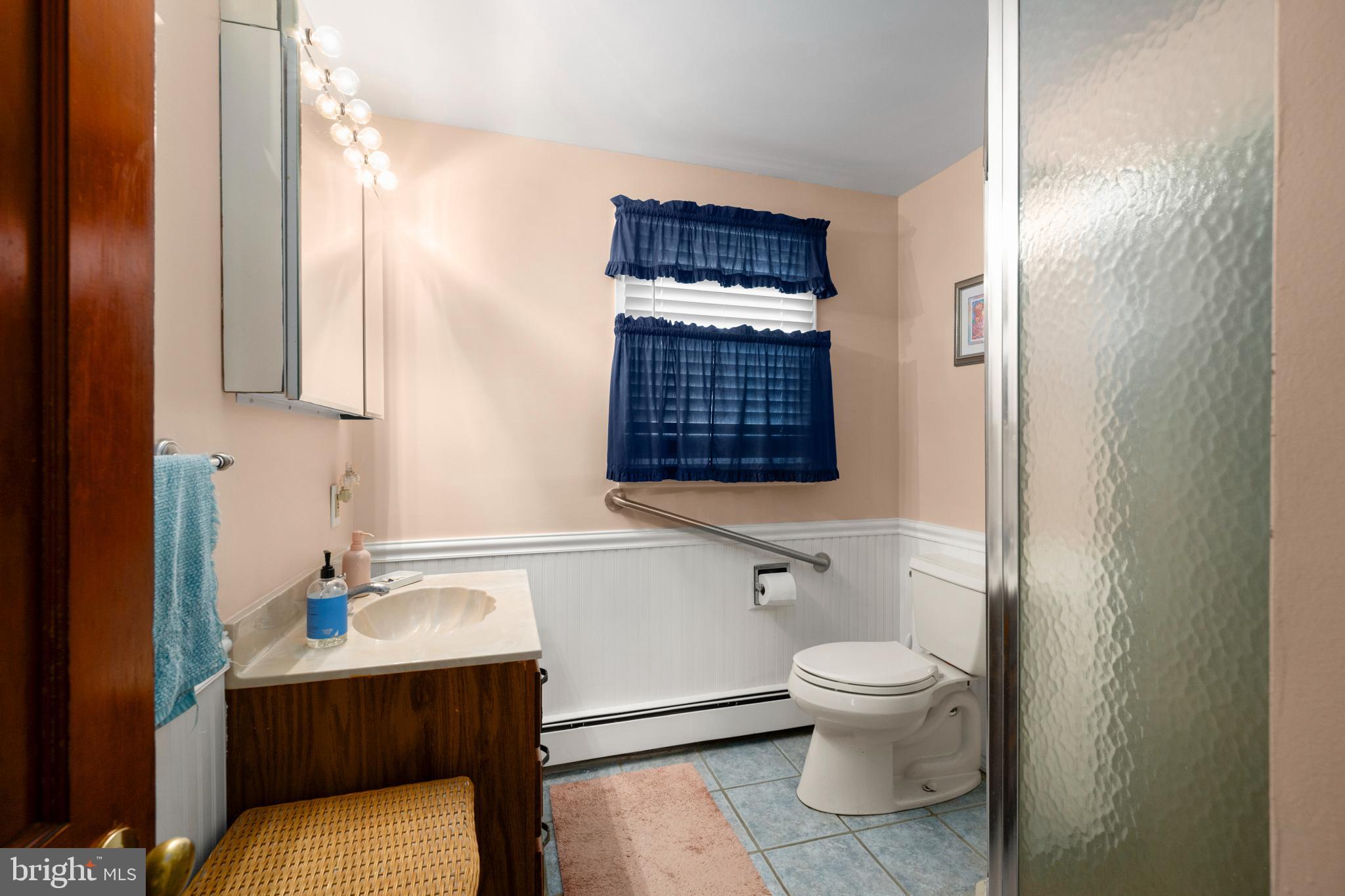 33 19th Street Surf City, NJ 08008 - Photo 21 of 63 a bathroom with a sink a toilet and shower