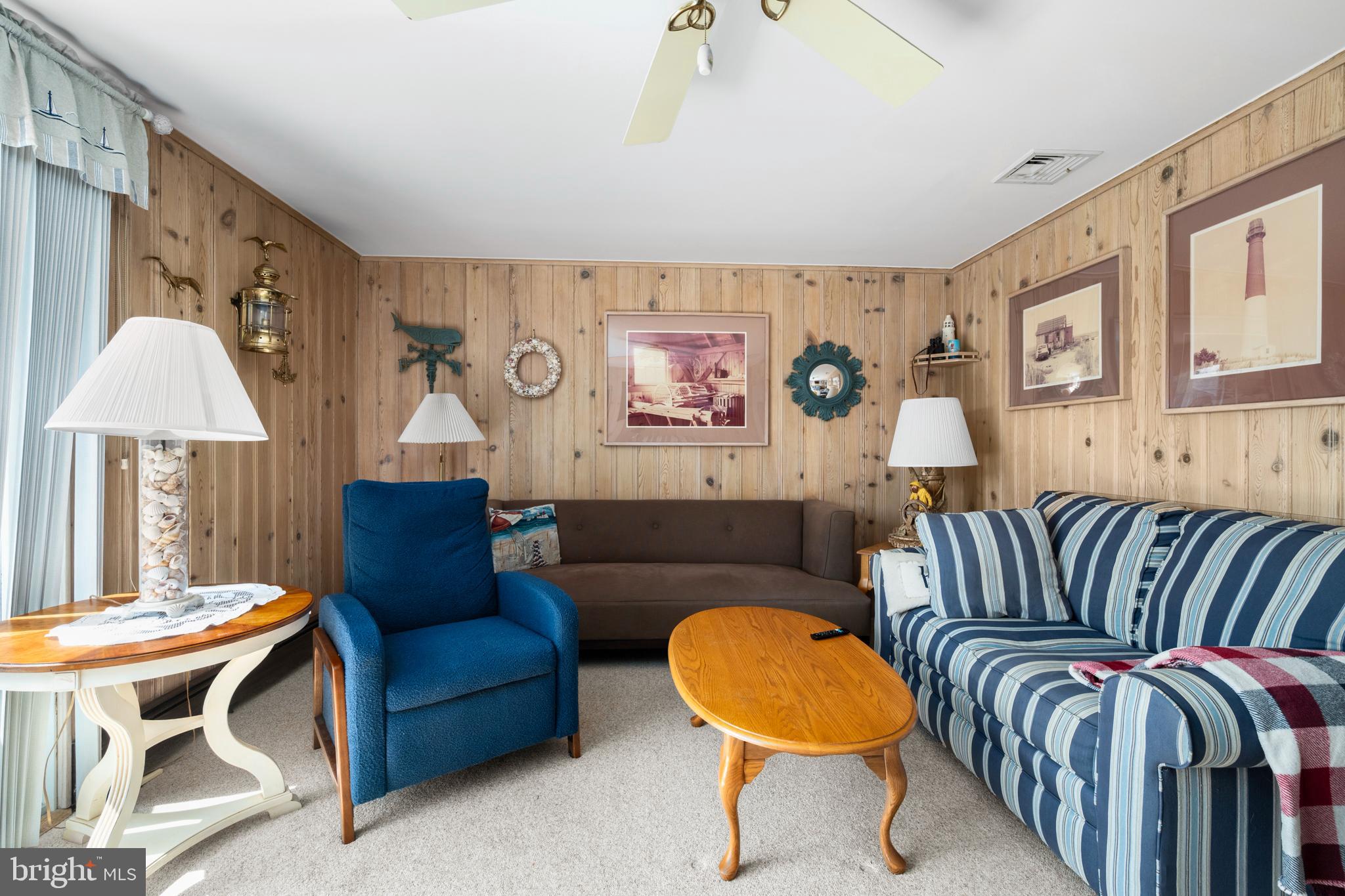 33 19th Street Surf City, NJ 08008 - Photo 24 of 63 a living room with furniture a lamp and a window