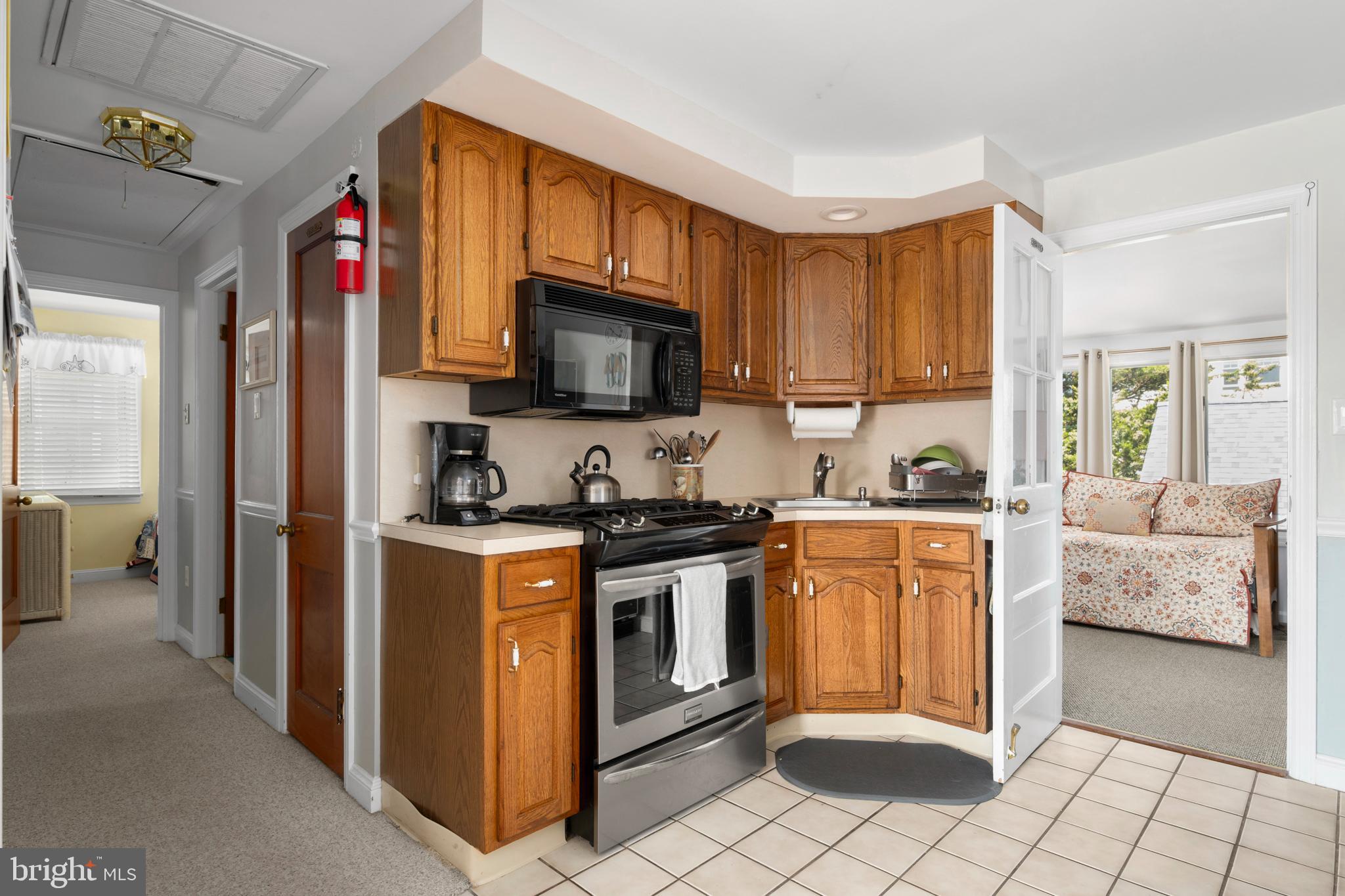 33 19th Street Surf City, NJ 08008 - Photo 28 of 63 a kitchen with stainless steel appliances granite countertop a stove top oven a sink dishwasher and a refrigerator