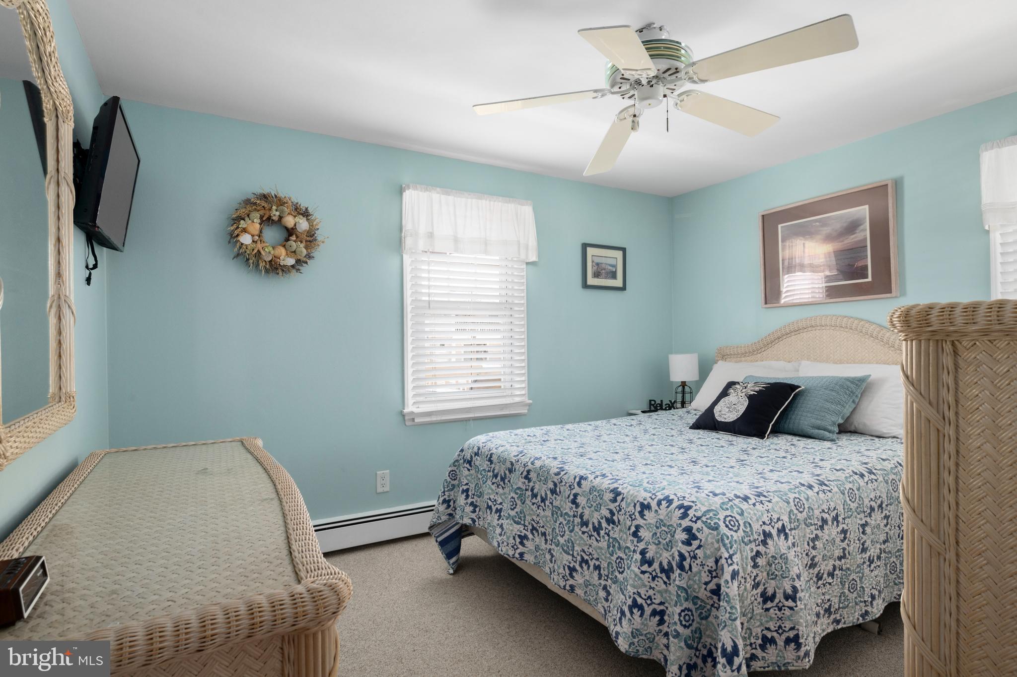 33 19th Street Surf City, NJ 08008 - Photo 30 of 63 a bedroom with a bed and a chandelier