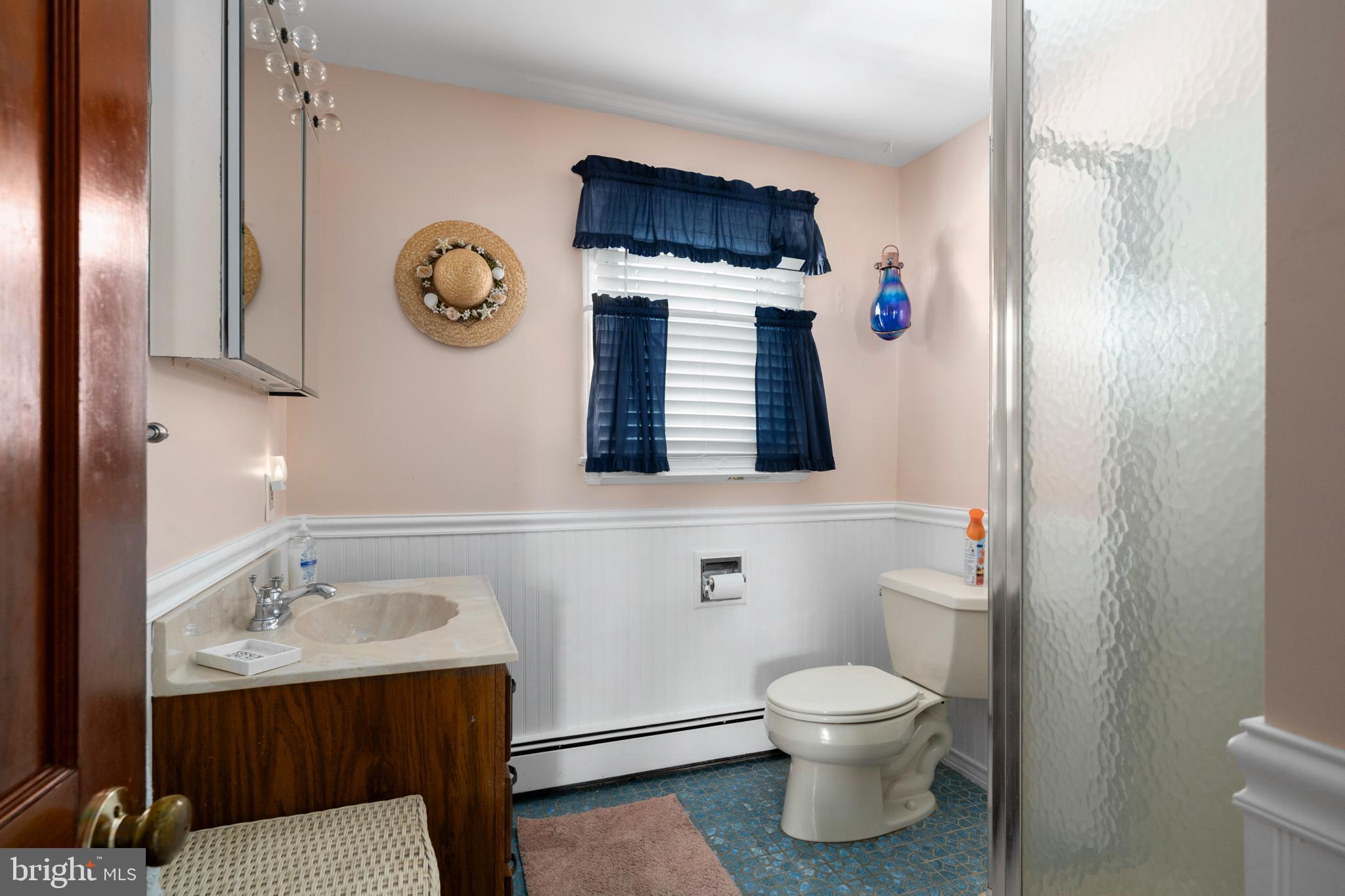 33 19th Street Surf City, NJ 08008 - Photo 33 of 63 a bathroom with a toilet sink and mirror