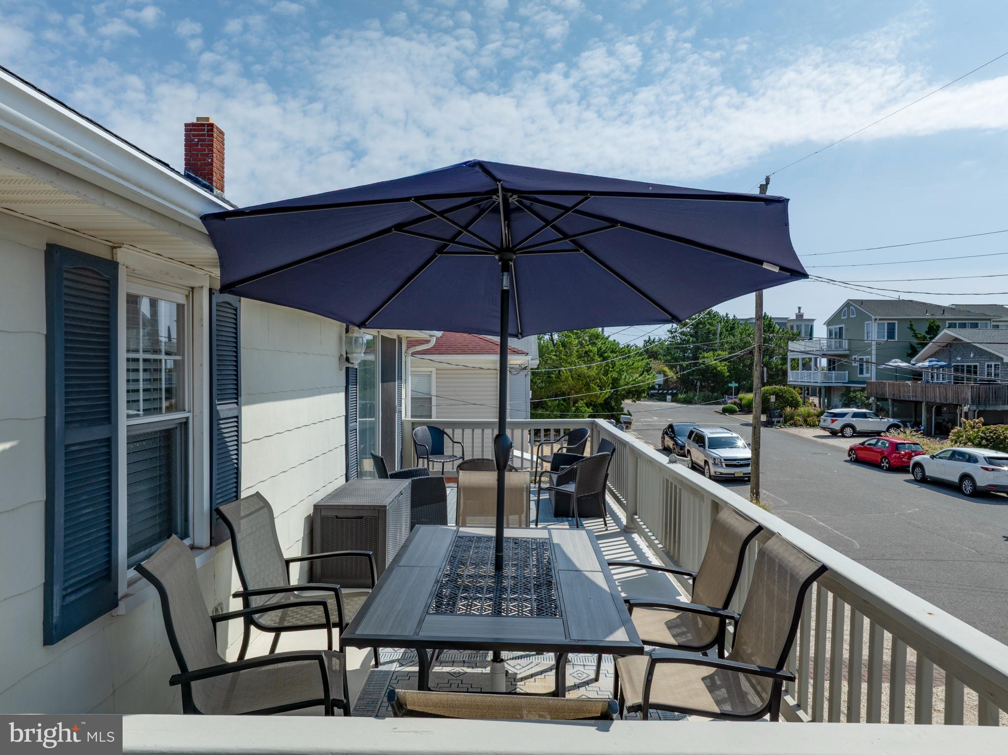 33 19th Street Surf City, NJ 08008 - Photo 37 of 63 a view of a patio with table and chairs under an umbrella