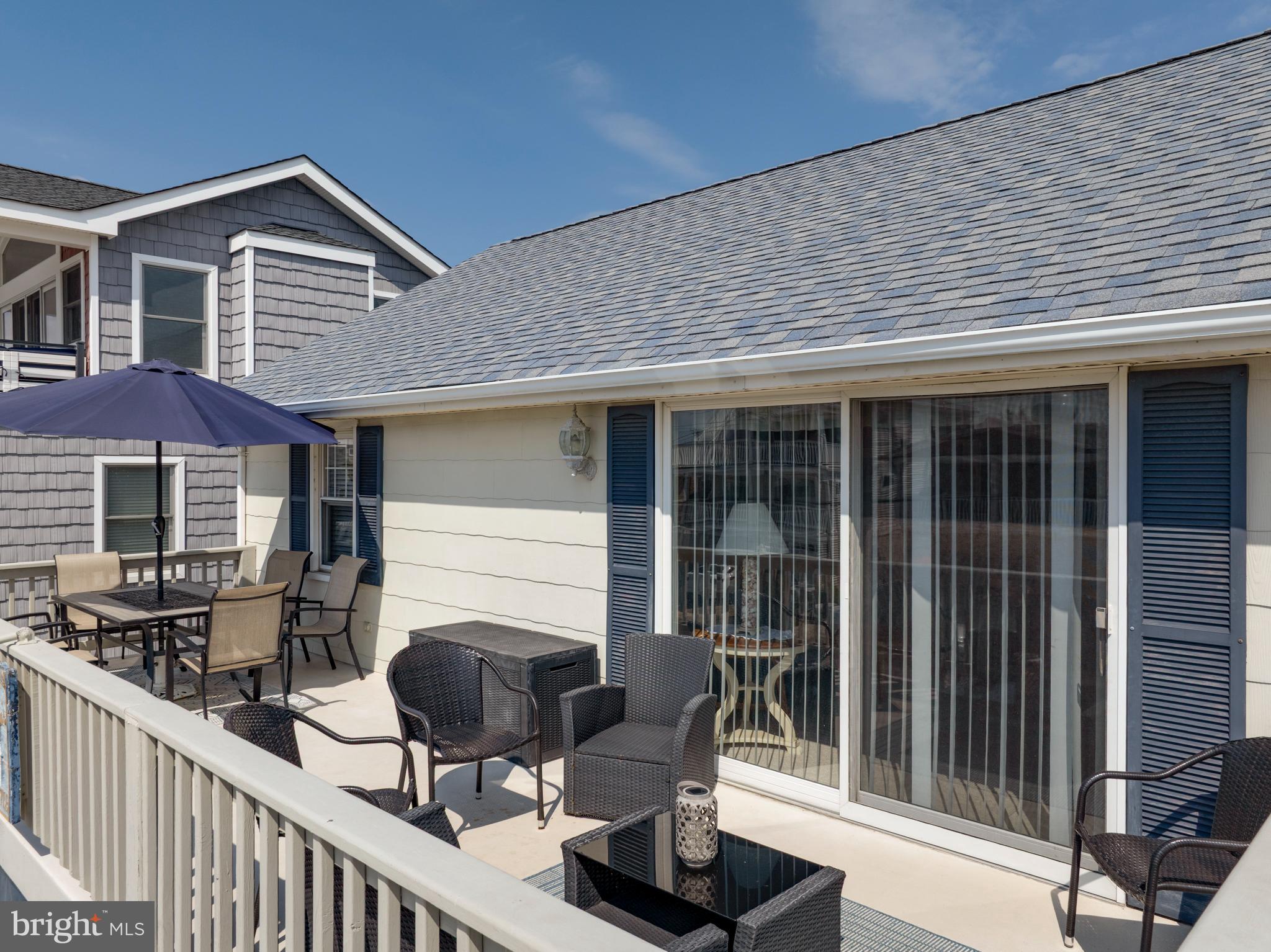 33 19th Street Surf City, NJ 08008 - Photo 38 of 63 a front view of house with yard outdoor seating and barbeque oven