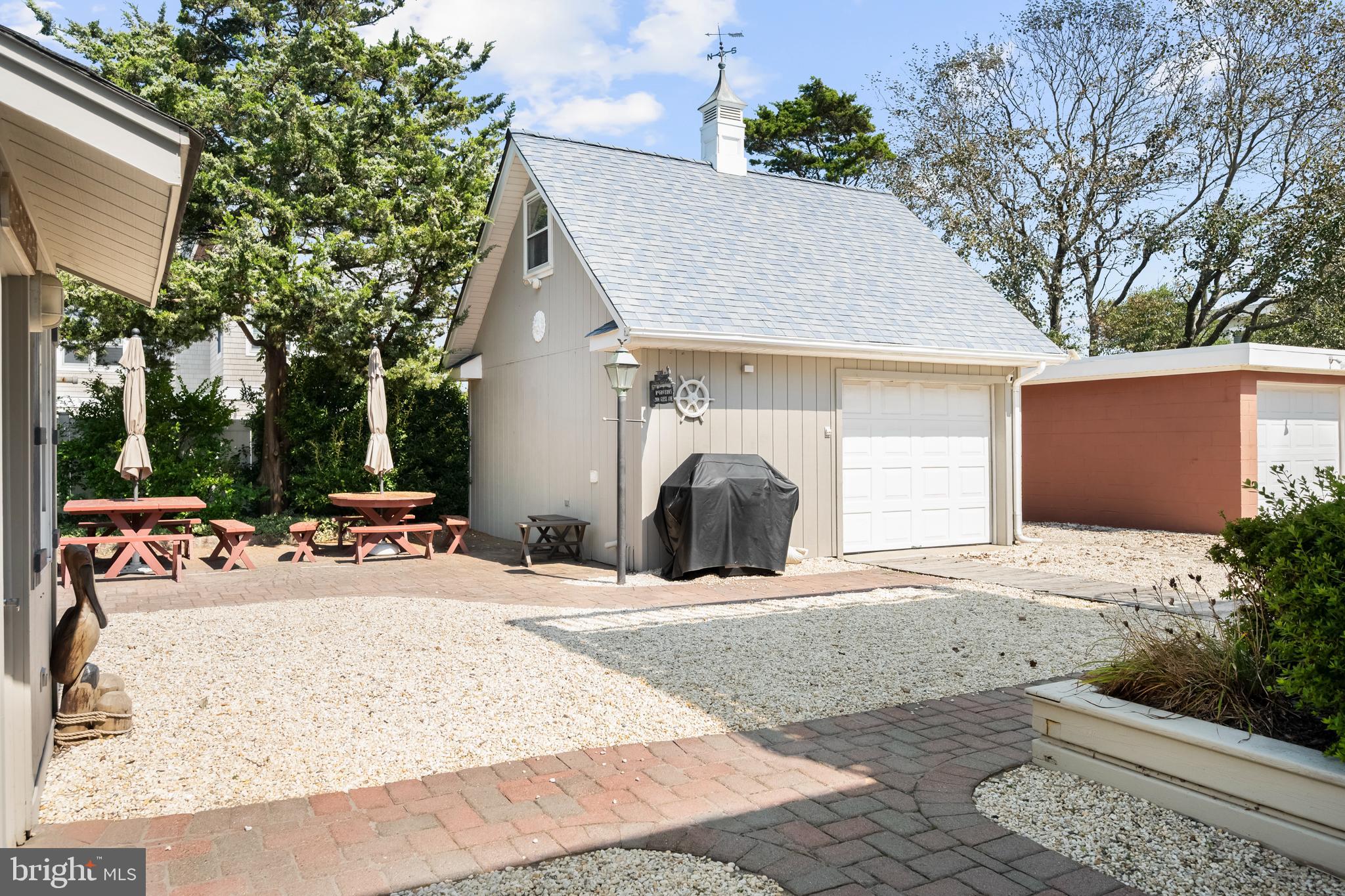 33 19th Street Surf City, NJ 08008 - Photo 43 of 63 a view of a white house with a yard and large trees