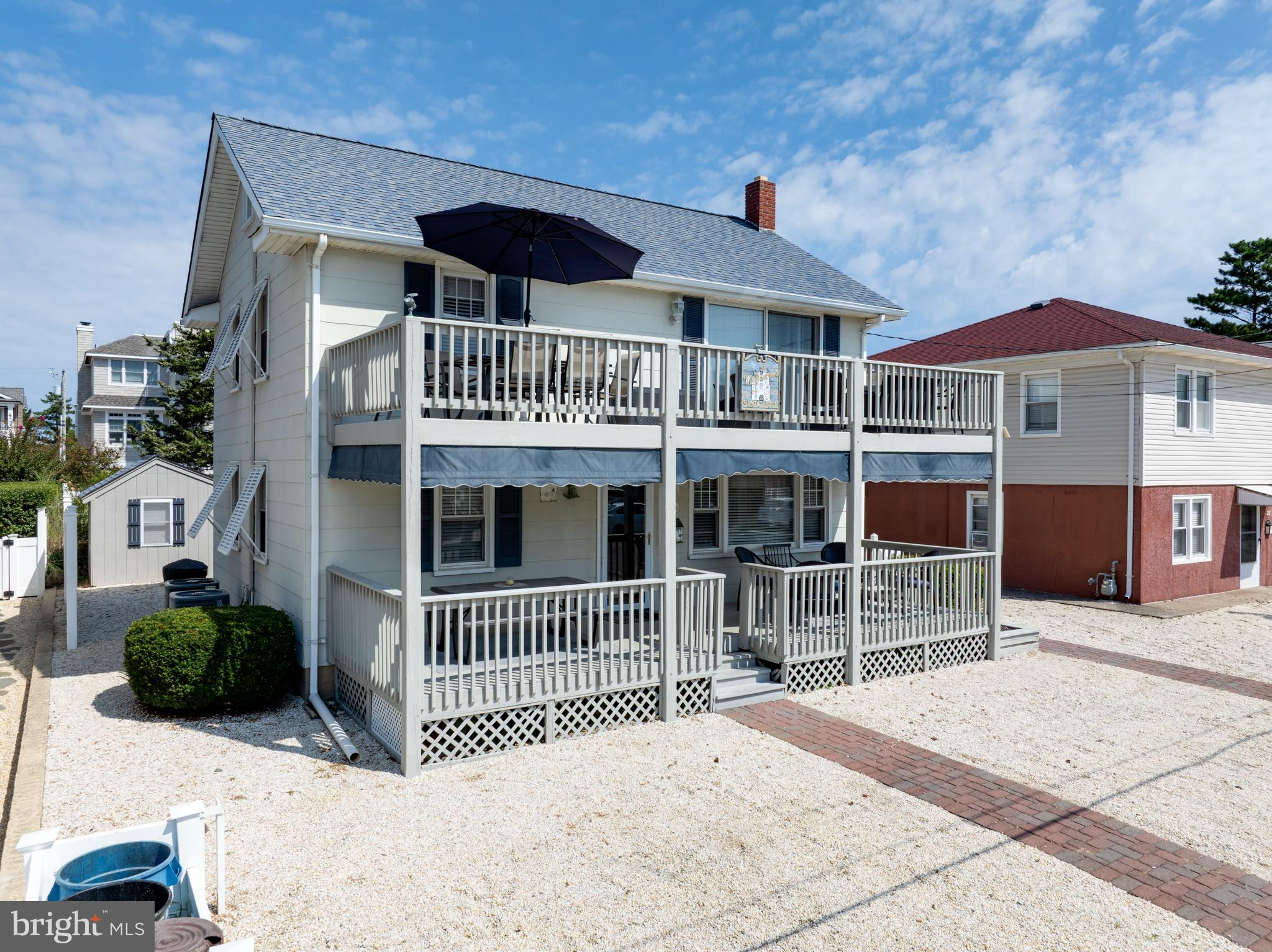 33 19th Street Surf City, NJ 08008 - Photo 47 of 63 a front view of a house with a garden